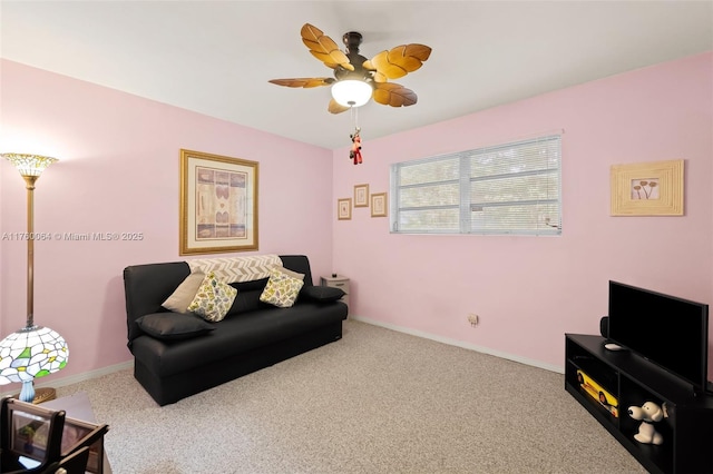 living room featuring a ceiling fan, carpet, and baseboards