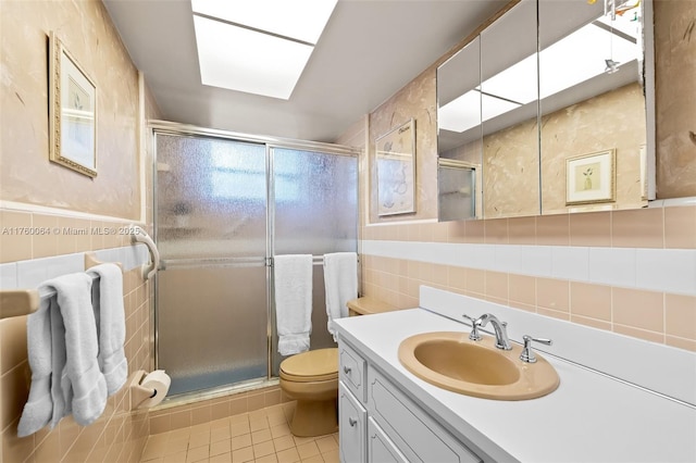 full bath featuring toilet, tile walls, tile patterned floors, and a shower stall