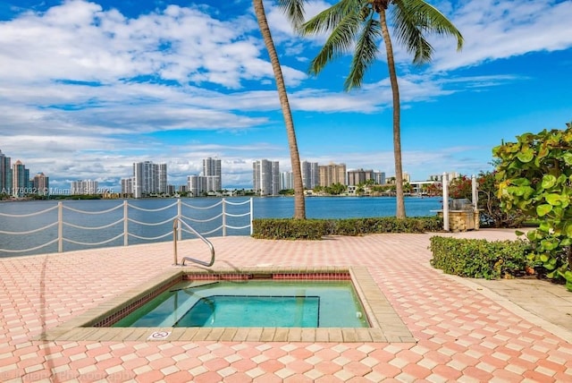 view of swimming pool with a water view, a city view, and a community hot tub