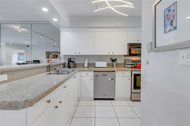 kitchen featuring light stone counters, appliances with stainless steel finishes, white cabinets, marble finish floor, and a sink