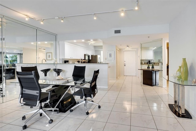 office area featuring light tile patterned flooring and visible vents