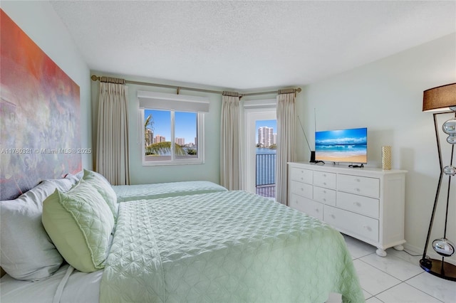 bedroom featuring light tile patterned floors and a textured ceiling