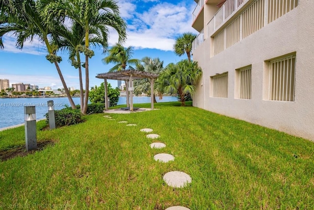 view of yard featuring a pergola and a water view