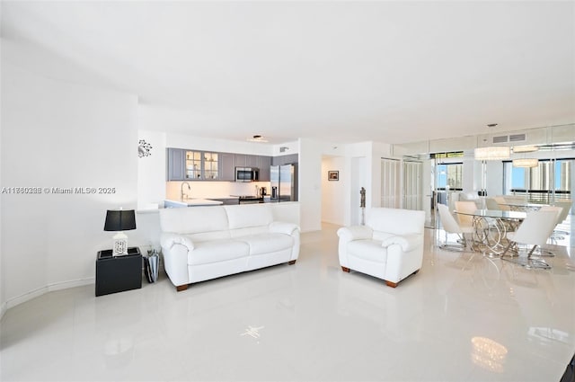 living area with baseboards and visible vents