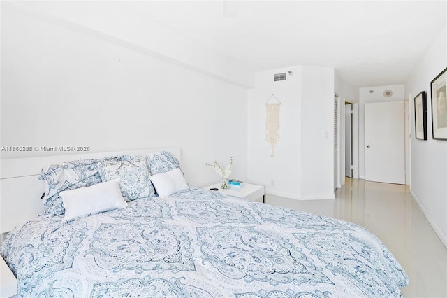 bedroom featuring baseboards and visible vents