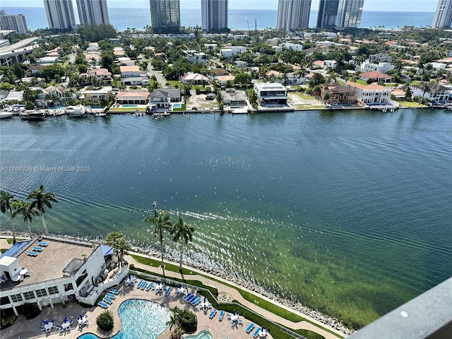 drone / aerial view featuring a water view and a view of city