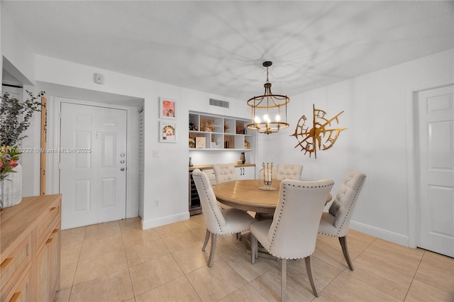 dining space with light tile patterned floors, visible vents, baseboards, and a notable chandelier