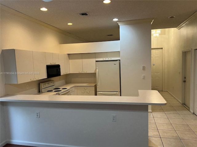 kitchen with visible vents, light countertops, a peninsula, light tile patterned flooring, and white appliances