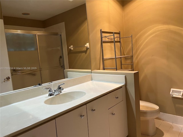 full bath featuring tile patterned flooring, a shower stall, baseboards, toilet, and vanity