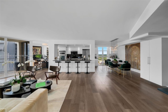 living area with a notable chandelier and wood finished floors