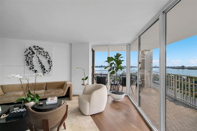1000 Quayside Ter Unit 1812, Miami, FL 33138 - living room with wood finished floors, a wall of windows, and a water view