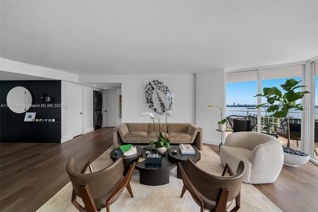 1000 Quayside Ter Unit 1812, Miami, FL 33138 - living area with a wall of windows, wood finished floors, baseboards, and stacked washing maching and dryer