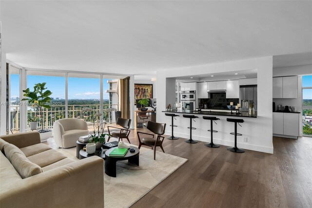 1000 Quayside Ter Unit 1812, Miami, FL 33138 - living area with a wall of windows, baseboards, and wood finished floors