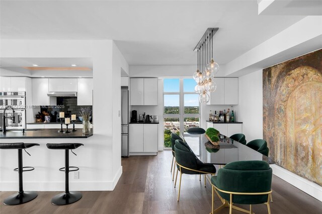 1000 Quayside Ter Unit 1812, Miami, FL 33138 - kitchen with under cabinet range hood, dark countertops, and modern cabinets