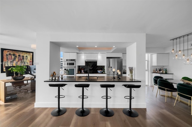1000 Quayside Ter Unit 1812, Miami, FL 33138 - kitchen featuring a kitchen bar, dark countertops, modern cabinets, and appliances with stainless steel finishes