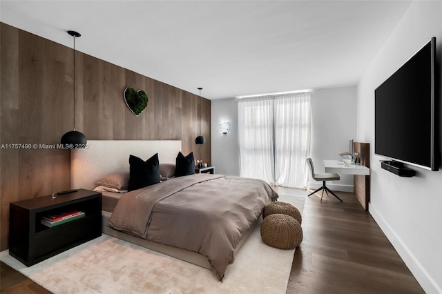 1000 Quayside Ter Unit 1812, Miami, FL 33138 - bedroom featuring wooden walls, an accent wall, baseboards, and wood finished floors