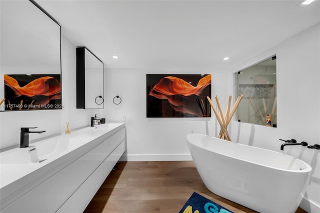 1000 Quayside Ter Unit 1812, Miami, FL 33138 - full bathroom featuring baseboards, double vanity, wood finished floors, a soaking tub, and a sink