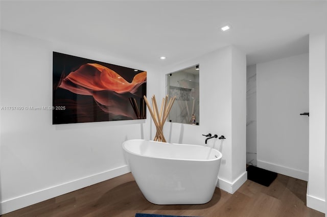 1000 Quayside Ter Unit 1812, Miami, FL 33138 - bathroom featuring a freestanding tub, wood finished floors, baseboards, and walk in shower
