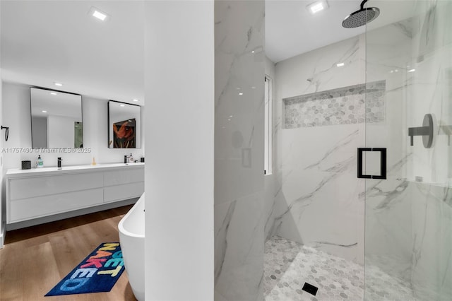 1000 Quayside Ter Unit 1812, Miami, FL 33138 - bathroom featuring a sink, wood finished floors, a marble finish shower, double vanity, and a freestanding bath