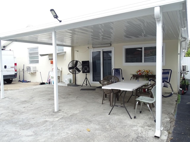 view of patio / terrace featuring an AC wall unit and outdoor dining area