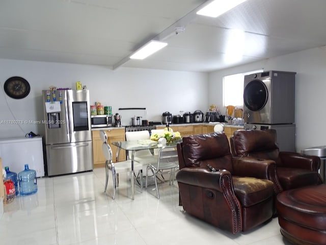 interior space featuring light tile patterned flooring and stacked washer / drying machine