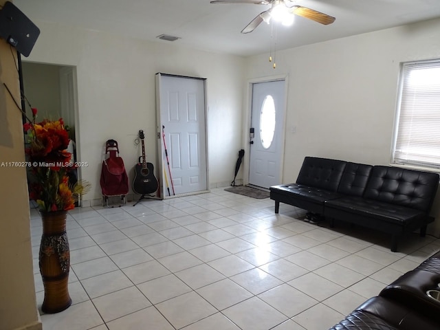 foyer entrance featuring light tile patterned flooring, a ceiling fan, and visible vents