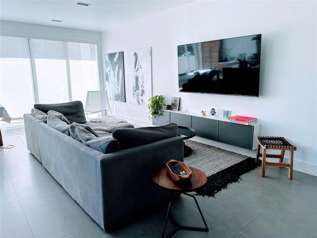 living area featuring baseboards