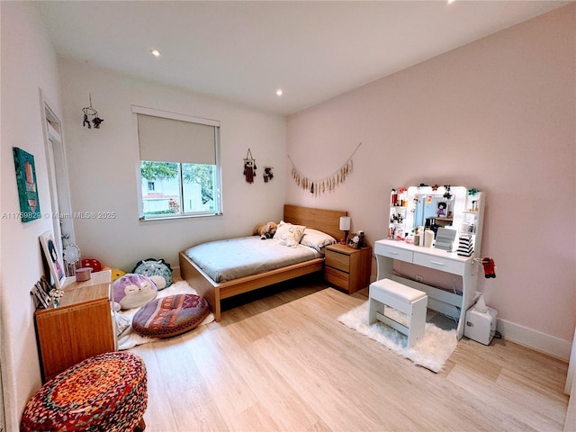 bedroom with recessed lighting, baseboards, and light wood-style floors