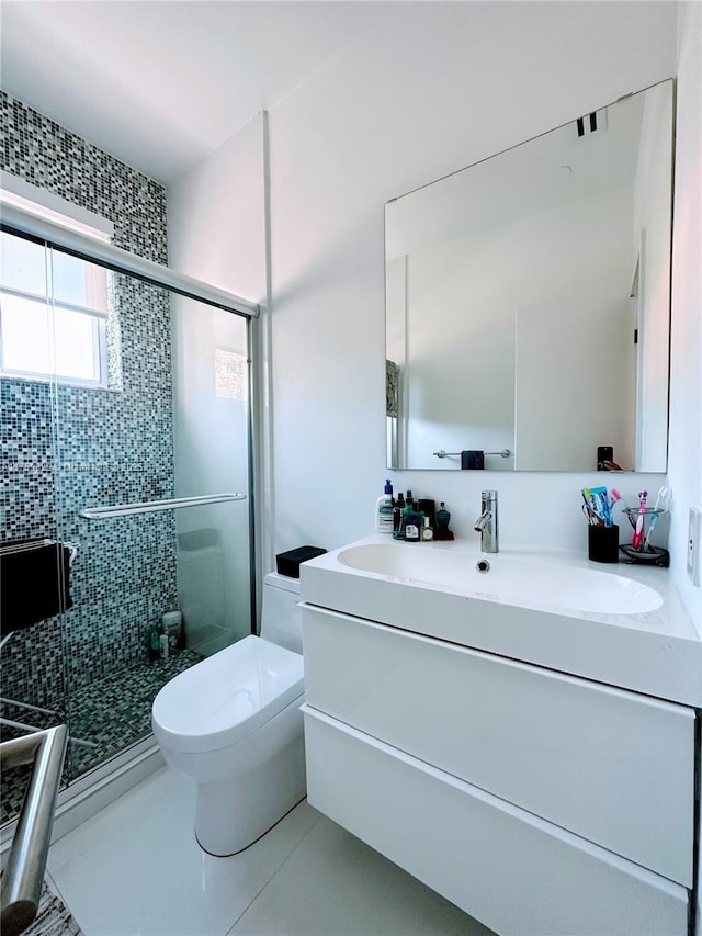 bathroom with vanity, a shower stall, toilet, and tile patterned flooring