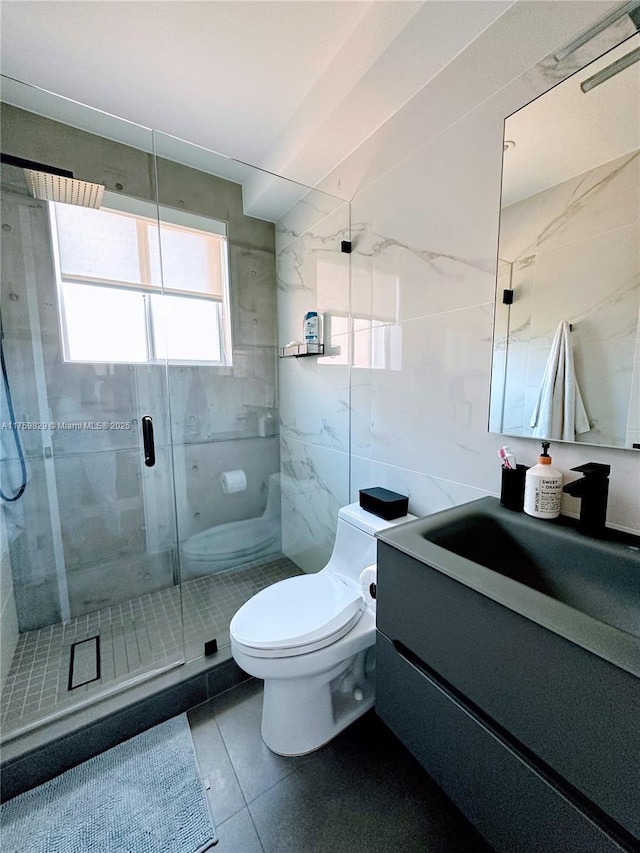 full bath with tile walls, a stall shower, toilet, and vanity