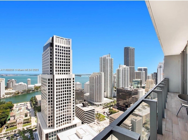 balcony with a water view and a city view