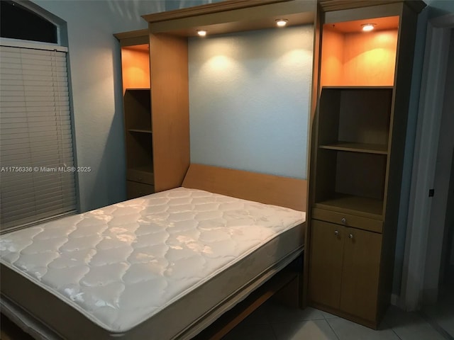 bedroom with light tile patterned floors