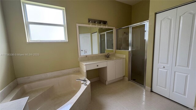 full bathroom featuring a stall shower, a closet, tile patterned flooring, a bath, and vanity