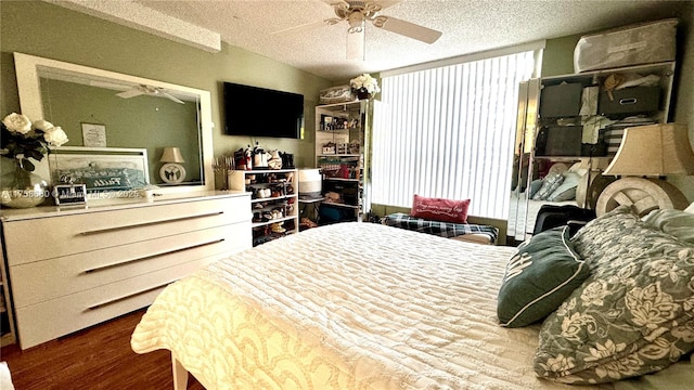 bedroom featuring a textured ceiling, ceiling fan, and dark wood-style flooring