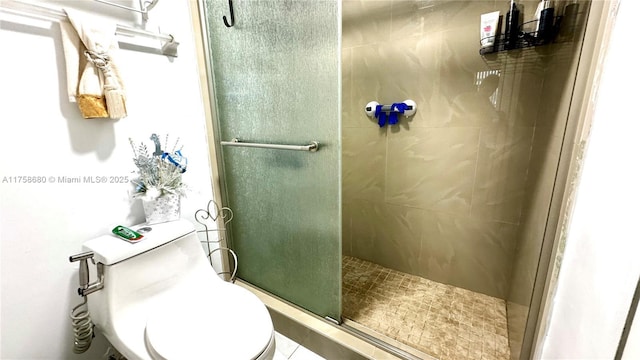 bathroom featuring a stall shower and toilet