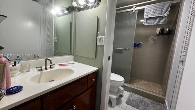 full bathroom featuring vanity, a shower stall, toilet, and tile patterned floors