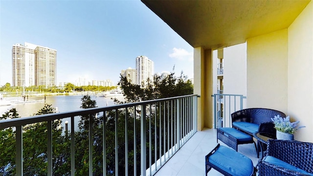 balcony with a water view and a city view