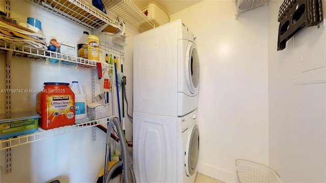 laundry room featuring laundry area and stacked washer / dryer