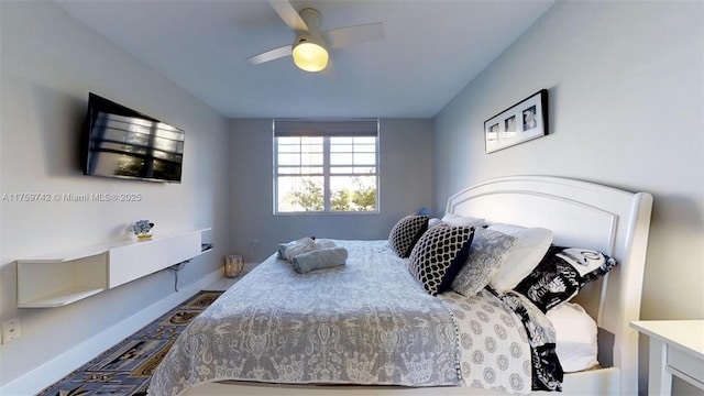 bedroom featuring a ceiling fan and baseboards