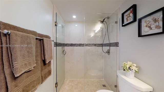 full bathroom featuring toilet and a shower stall