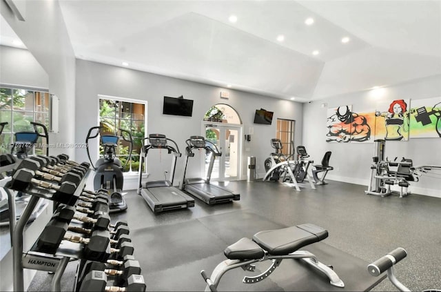 exercise room with recessed lighting, baseboards, and high vaulted ceiling