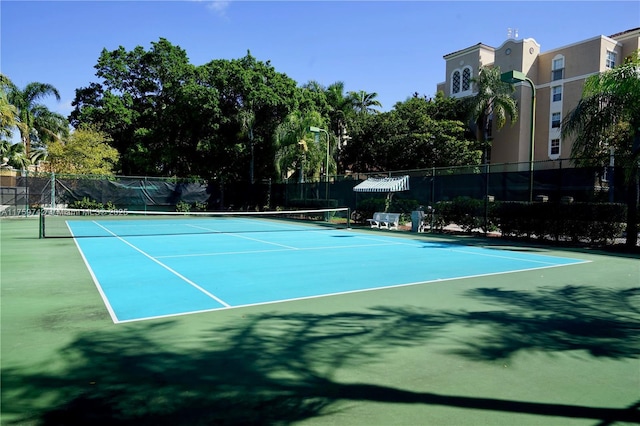 view of sport court featuring fence