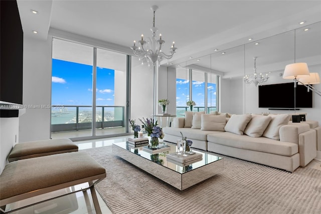 living area featuring a notable chandelier, recessed lighting, and expansive windows