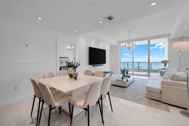 dining space featuring visible vents, recessed lighting, a wall of windows, baseboards, and a chandelier