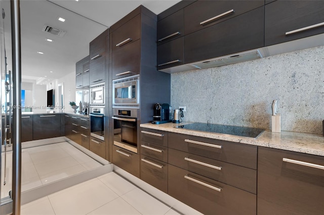 kitchen featuring stainless steel appliances, tasteful backsplash, modern cabinets, and visible vents