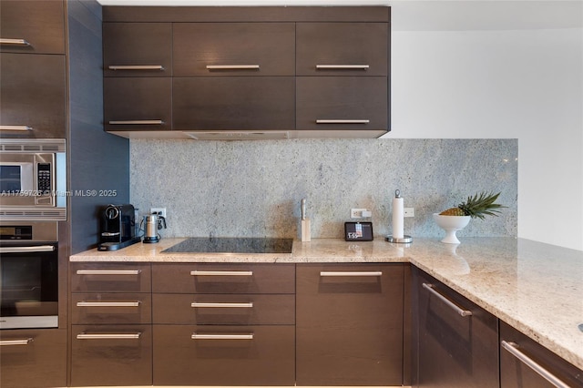 kitchen with dark brown cabinetry, decorative backsplash, appliances with stainless steel finishes, and modern cabinets