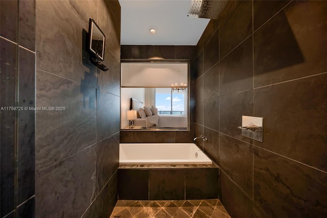 full bath featuring tile walls and tiled tub