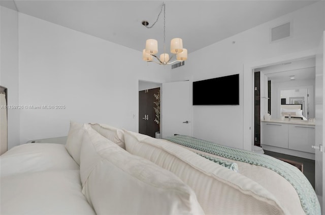 bedroom featuring visible vents and an inviting chandelier