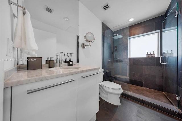 bathroom featuring visible vents, toilet, and a stall shower