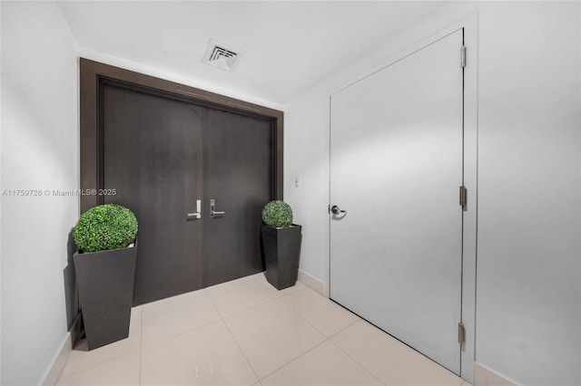 interior space featuring tile patterned floors and visible vents